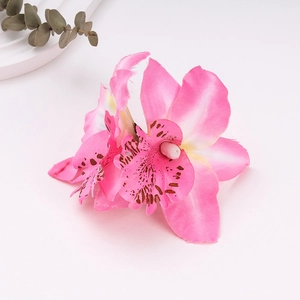 Detail of pink faux orchid hair clip with gradient petals and realistic silk texture