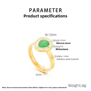 Detailed view of golden stainless steel ring with green natural stone and white rhinestones