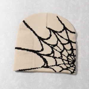 Detailed close-up of knitted spider web pattern on a beige Y2K beanie hat