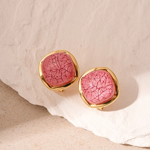 Detailed close-up of vintage resin square studs with pink marble texture in gold frame