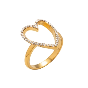Detailed view of hollow gold heart ring with pavé-set zircons on white background