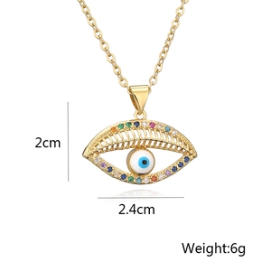Macro shot of 18K gold evil eye necklace with dimensions: 2cm height and 2.4cm width