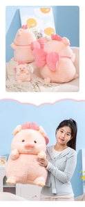 Close-up of pink pig plush toy featuring a large soft bow and ultra-soft fluffy texture