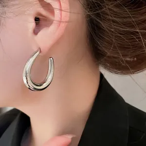 Minimalist silver U-shaped chunky hoop earrings with high-polished mirror finish