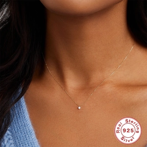 Minimalist S925 sterling silver gold necklace with round zircon on a female model