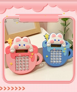 Close-up of pink and blue bunny shaped mini calculators with soft silicone texture