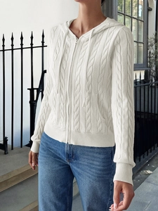 Detail of white cable knit zip-up hoodie showing texture, ribbed cuffs and drawstring hood