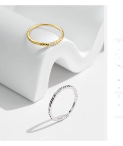 Detail of s925 silver irregular hammered texture ring with sparkling rectangle zircon