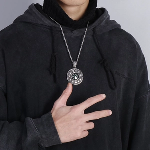 Men's stainless steel compass pendant with star engraving on a silver twist chain
