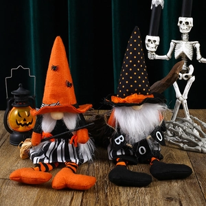 Halloween gnome plush set with orange witch hats and striped legs on wooden table