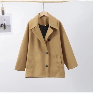 Detail of single-breasted lapel and wool-blend texture on camel loose jacket