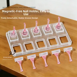 Detailed view of pink translucent nail tip holders on a clear acrylic base for display