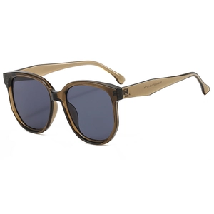 Lunettes de soleil œil-de-chat modernes avec monture ambrée et verres gris foncé