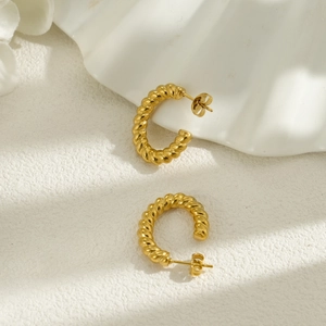 Detailed close-up of 18k gold-plated stainless steel twisted rope C-shaped hoop earrings