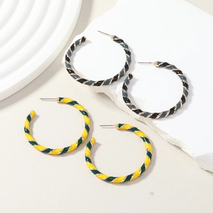 Detail view of two pairs of C-shaped hoop earrings with spiral twist design in multi-colors