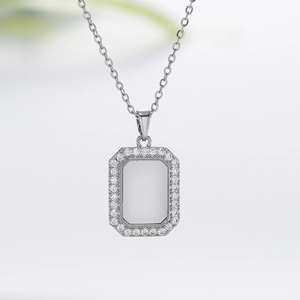 Close-up of silver geometric square pendant with white zircon inlay on thin chain