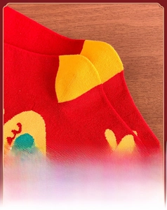 Detailed macro view of 3D stereo heel design on red cotton socks with floral patterns