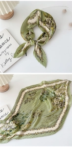 Detailed macro shot of vintage floral pleated silk scarf in sage green and beige colors