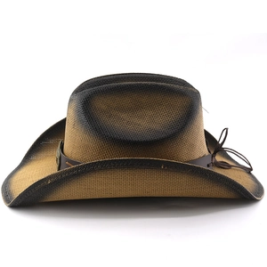 Close-up of woven straw cowboy hat with vintage spray finish and leather bull-head band