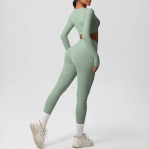 Detail of mint green yoga set featuring high-waisted leggings and long-sleeve crop top