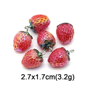 Macro detail of red strawberry resin charms with rainbow finish and 2.7x1.7cm dimensions