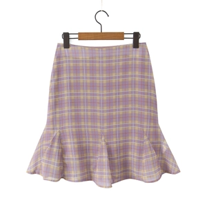 Close-up of a purple and yellow plaid mini skirt with ruffled fishtail hemline