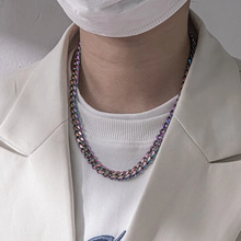 Close-up of rainbow stainless steel flat snake chain necklace on model's neck