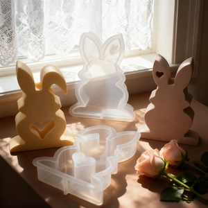 Macro detail of silicone rabbit molds and finished crafts with heart-shaped cutout design