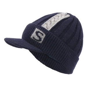 Detailed close-up of dark blue knit beanie with visor, grey stripes and S logo patch