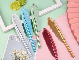 Flat lay of five metallic feather pens in silver, blue, green, red, and gold colors
