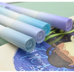 Macro shot of gradient blue and purple highlighter caps with artistic paper background