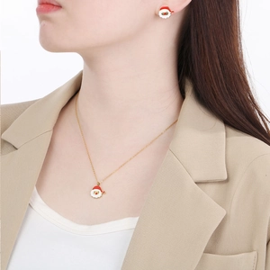 Golden stainless steel jewelry set featuring cartoon Santa Claus necklace and stud earrings