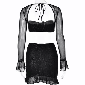 Detail of black sequined mesh two-piece set featuring backless lace-up and ruffled hemline