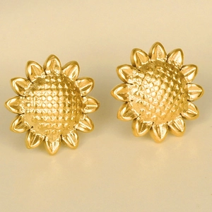 Macro shot of 18k gold plated stainless steel sunflower studs with detailed petals