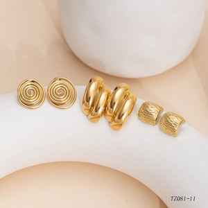 Three-piece golden earring set with spiral scrolls and textured metal hoops