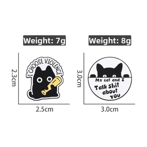 Detail view of two funny black cat enamel pins with humorous quotes and size specifications