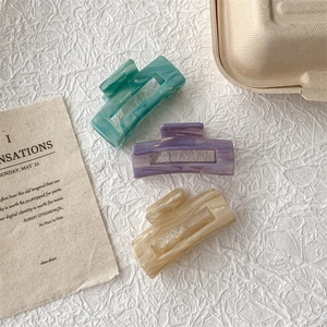 French vintage acetate hair claws in green, purple, and beige with marble patterns