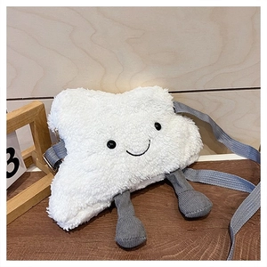 Detail of plush cloud-shaped crossbody bag with corduroy legs on a wooden background