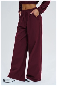 Detail showing high-waist loose wide-leg pants with elastic waistband and side pocket in wine red