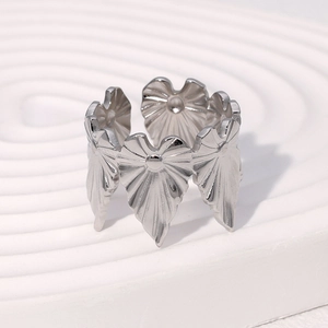 Macro detail of adjustable silver leaf ring with textured radiating heart elements