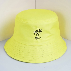 Detailed close-up of black embroidered palm tree on neon yellow canvas bucket hat