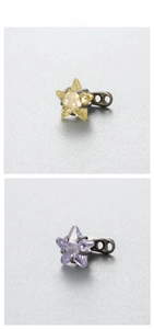 Detailed view of 6mm star-shaped zircon piercing studs in yellow and purple stone options