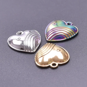 Detailed view of heart-shaped pendants in gold, silver, and rainbow steel finish