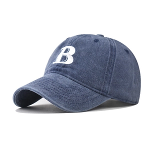 Macro detail of washed cotton baseball cap featuring high-quality white B letter embroidery