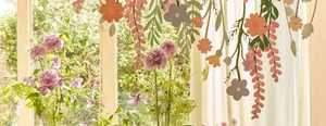 Detail of colorful flower banner wall stickers on window with orange and purple petals