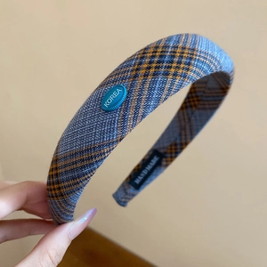 Detail of blue plaid fabric headband featuring a hand-made label and Korea tag