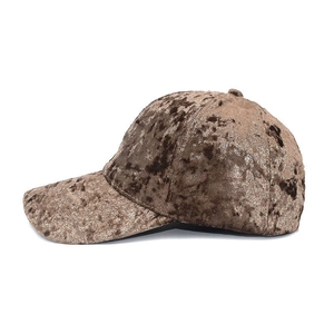 Detailed side view of a bronze velvet baseball cap featuring a rich reflective texture