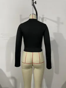 Vue arrière du crop top noir à manches longues en tricot extensible et coupe ajustée