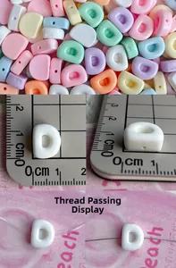 Detail of 10mm macaron resin alphabet beads showing horizontal holes and size measurements
