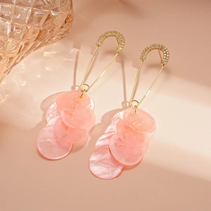 Detail of pink shell earrings with golden pin design and pavé rhinestones